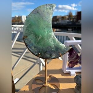 Natural Feathered Fluorite moon carving on stand. Beautiful piece, one of a kind